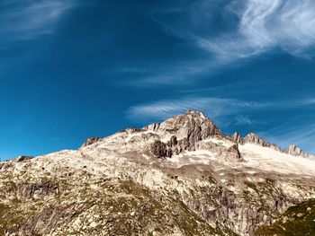 Rocky mountain peak at furka pass, swiss alps, kanton valais, switzerland