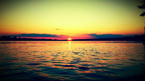 Scenic view of sea against romantic sky at sunset