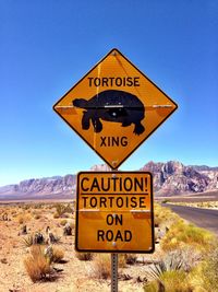 Information sign on road against sky