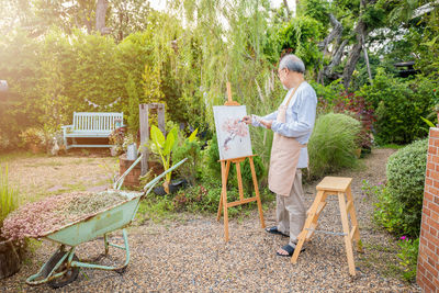 Rear view of man working at park