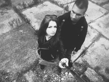 High angle portrait of young couple sitting outdoors