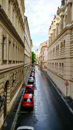 Cars on road in city against sky