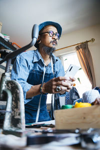 Man working over fabric on table