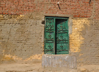 Closed door on brick wall of building