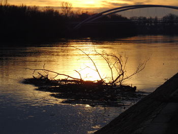 Scenic view of river at sunset