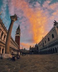 Panoramic view of buildings in city against sky during sunset