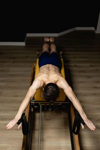 Low angle view of young woman exercising in gym