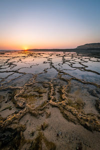 Scenic view of sea against clear sky during sunset