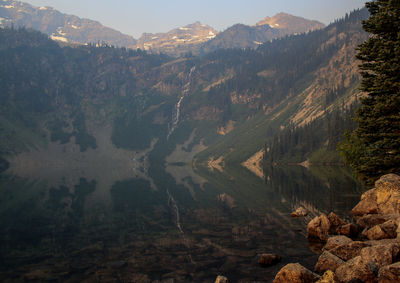 Scenic view of trees and mountains against sky