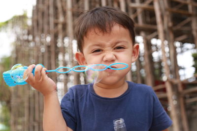 Portrait of boy holding bubbles