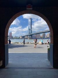 People in front of buildings against sky