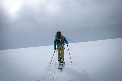 Rear view of umbrella on snowcapped mountain