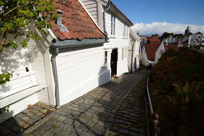 Footpath amidst houses and buildings in town
