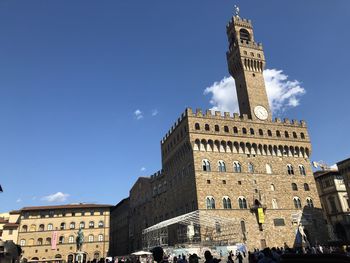 Low angle view of historical building against blue sky