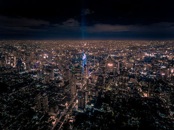 High angle view of city lit up at night