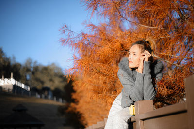 Woman standing in park during autumn