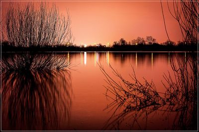 Scenic view of lake against sky during sunset