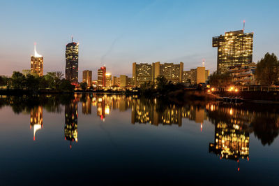 Reflection of illuminated buildings in city