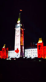 Low angle view of clock tower at night