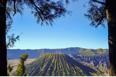 Scenic view of mountains against clear blue sky