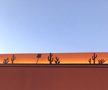 Low angle view of orange building against sky during sunset