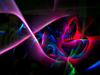 Close-up of light trails over black background