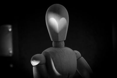 Close-up of figurine against black background