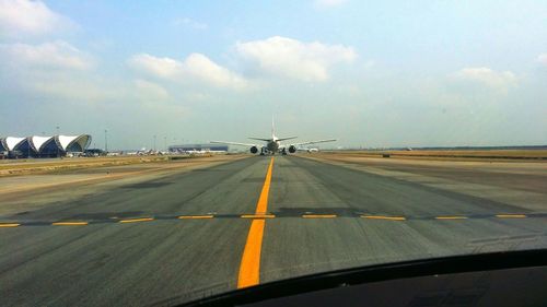 Road passing through dramatic sky