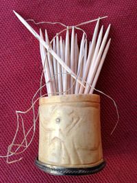 Close-up of toothpicks in container on table