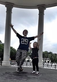 Full length of mother and daughter enjoying at gazebo