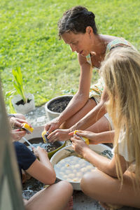 Mother with daughters cleaning potatoes, oland, sweden