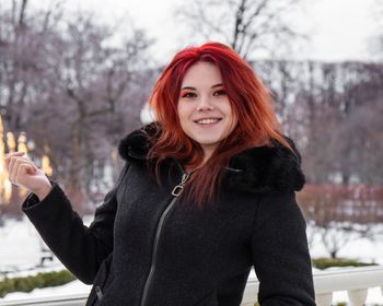 Portrait of smiling woman in snow