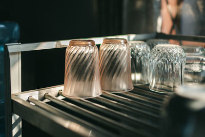 Close-up of drinking glasses on table