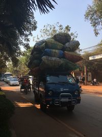 Cars on road against sky in city