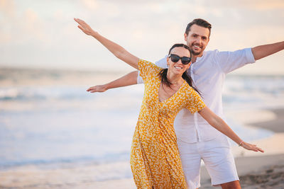 Full length of young woman standing at beach