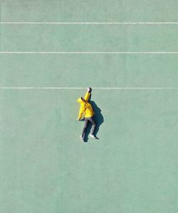 Directly above shot of man lying on playing field