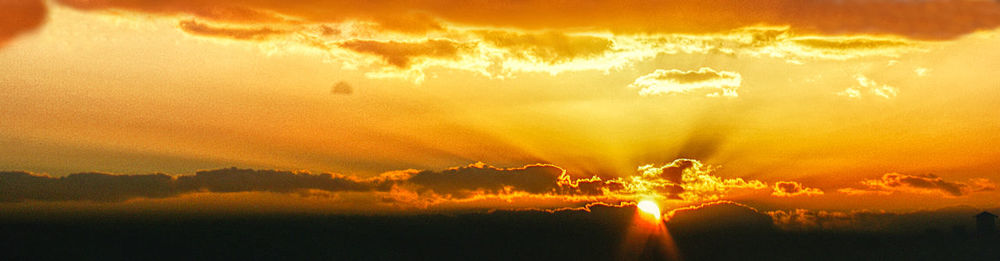 Scenic view of dramatic sky during sunset