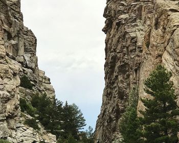 Low angle view of cliff against sky