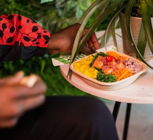 Midsection of man holding food on table