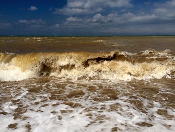 Scenic view of sea against cloudy sky