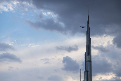 Low angle view of communications tower against sky