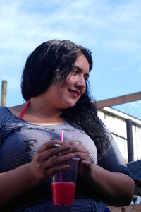 Portrait of young woman drinking glasses
