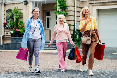 Portrait of female friends walking on street