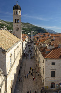 High angle view of people in historic building against sky