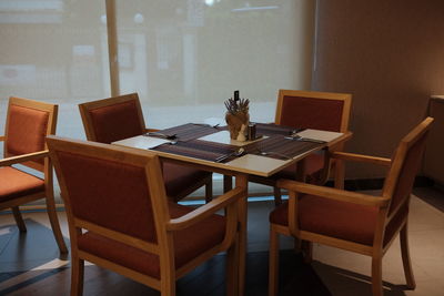 High angle view of empty chairs and tables in restaurant