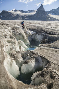 Man at meltwater pond, snowbird glacier, talkeetna mountains, alaska