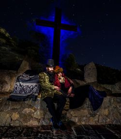 Rear view of woman standing at night