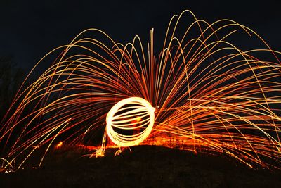 Firework display against clear sky at night