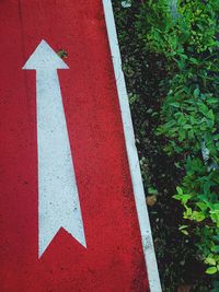 High angle view of arrow sign on road