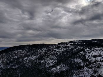 Scenic view of mountain against cloudy sky